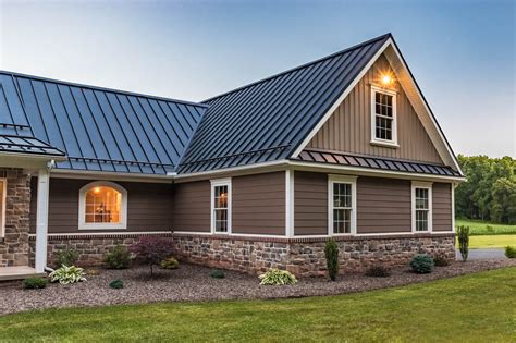 brown brick house with metal roof|matching brick and roof colors.